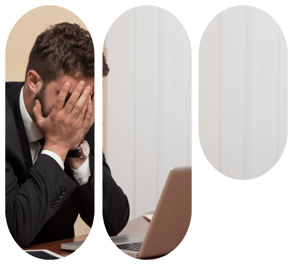 Stressed man in a suit covers his face at a desk beside a laptop, split into rounded panels.